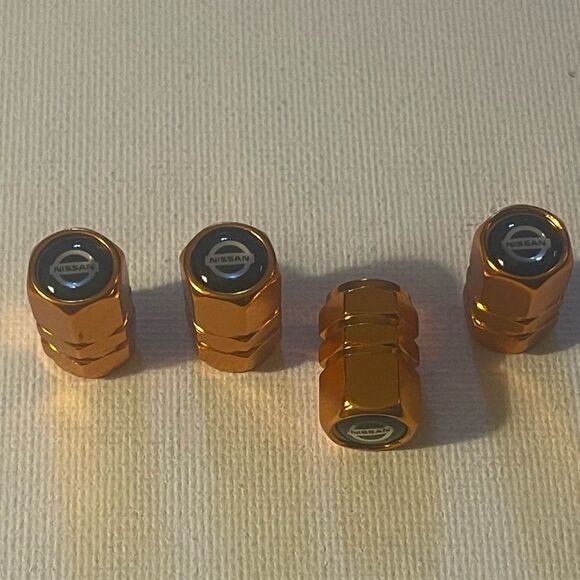 Nissan Logo Valve Stem caps in Gold set of 4 NWT - Picture 2 of 4
